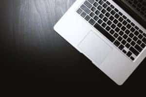 laptop keyboard on dark wood desktop
