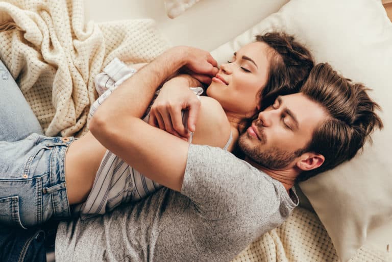 Married couple coddling and showing each other love in their happy marriage.
