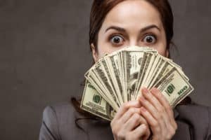 how to make money fast Woman holding money she made from her quick side hustle