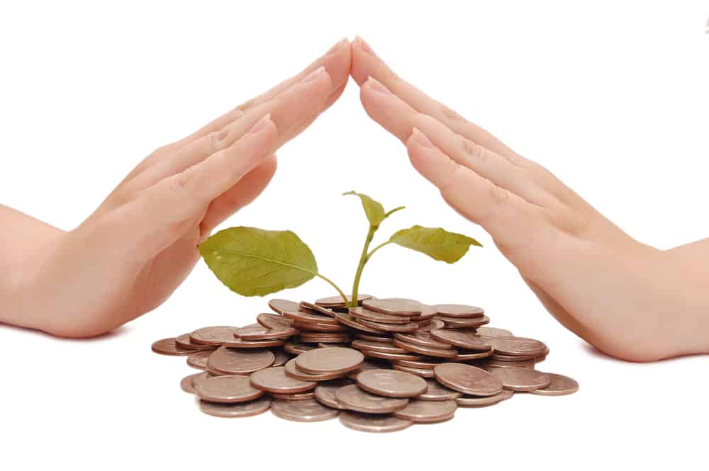 12 Better Money Habits of People Who Always Have Money 1 Female hands over a pile of money