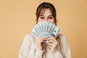 how to make a million dollars Beautiful young woman wearing sweater standing