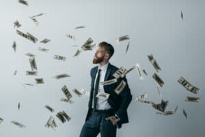 independently wealthy- man with money falling on him, raining money