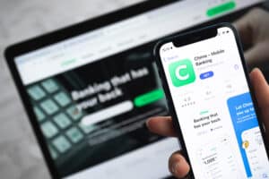 chime review Poltava, Ukraine - April 5, 2022: Chime app icon. Hand with mobile phone with application. Mobile banking and investment concept