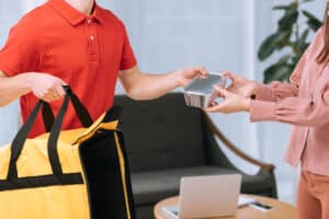 postmates vs. doordash man taking food out of delivery bad
