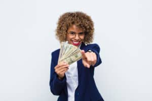 Side Hustles For Women young african american woman pointing at camera with a satisfied, confident, friendly smile, choosing you with euro banknotes