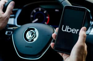 Man starting up their uber driver app to make extra cash