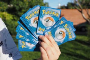 sell pokemon cardsA child holds some pokemon cards