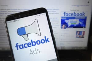 facebook side hustle course review Facebook Ads logo displayed on mobile phone