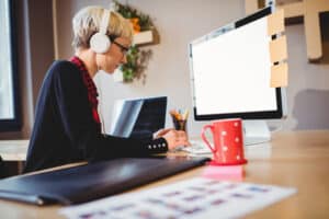 transcribe anywhere review transcription woman typing, computer and headphones