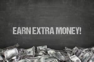 How To Make Extra Money Earn extra money text on black background with dollar pile