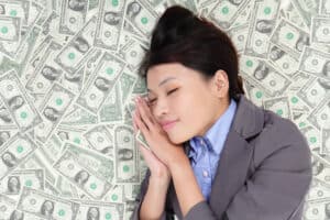 make money while you sleep Young business woman sleeping on money bed and have a good dream, asian beauty model