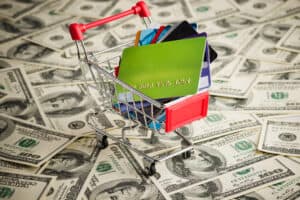 sell gift cards Credit card within shopping cart. Dollar background