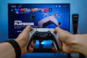 sell video games Sony PlayStation 5. New generation gaming computer. PS5 controller. Man playing video games