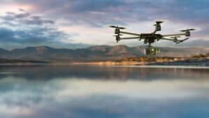 Make Money With A Drone 3D rendering of a drone equiped with a camera on a natural landscape