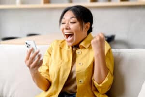 woman happy winning money using Online survey sites