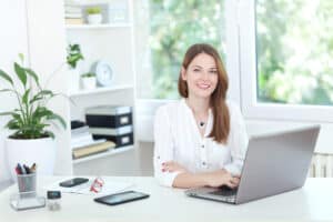 Side Hustles for Introverts, confident young woman sitting at working desk
